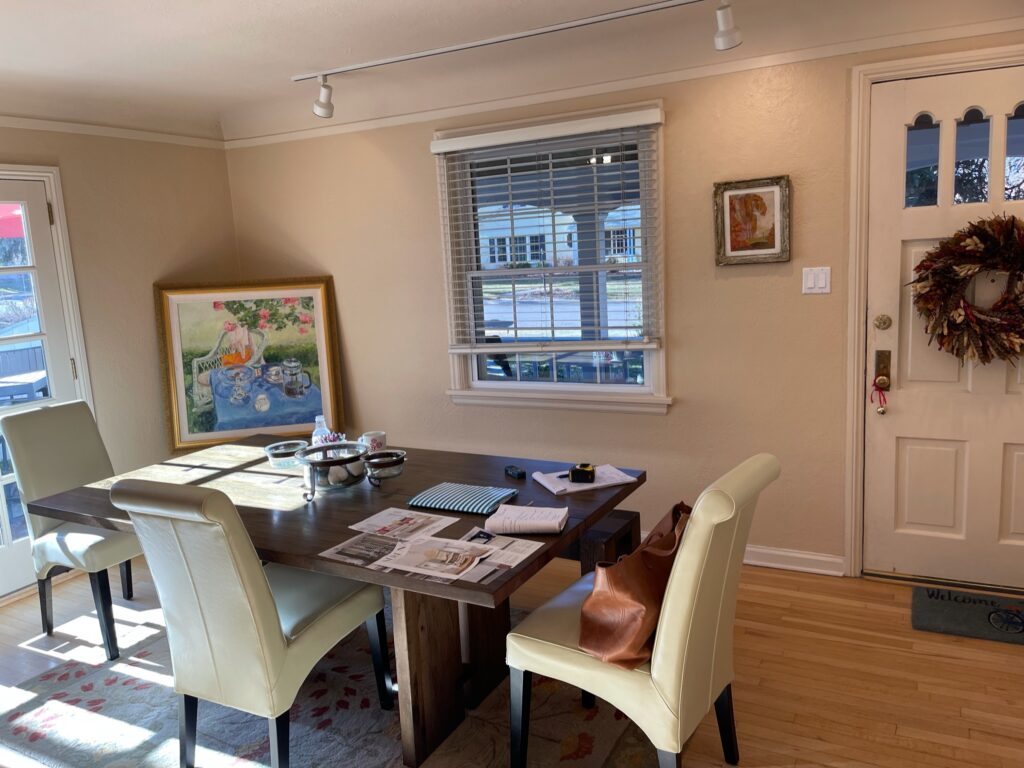 Dining area with table, chairs, and wall art.