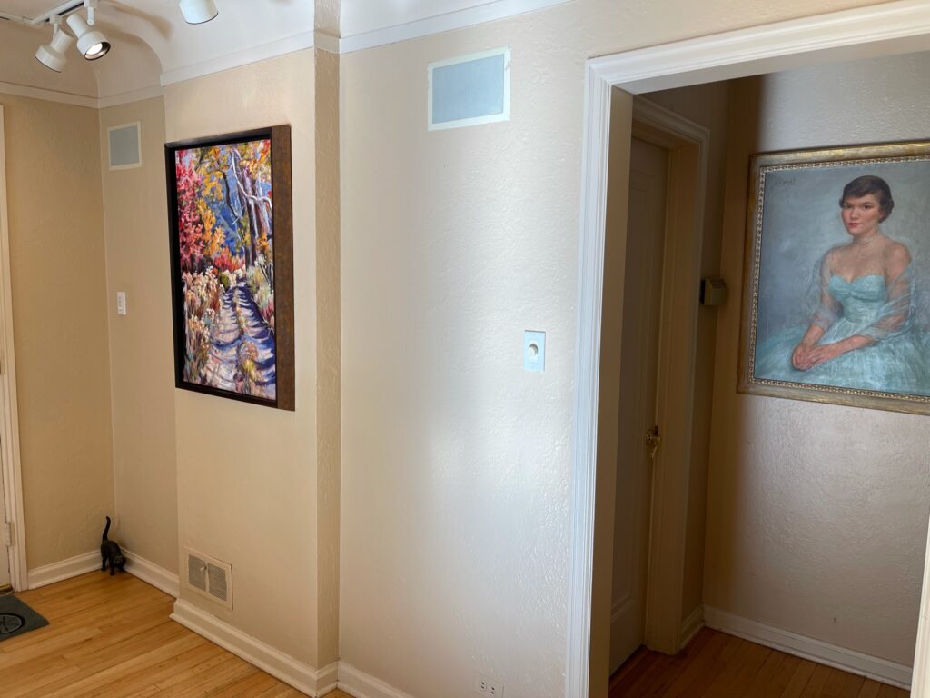 Hallway with two framed paintings.