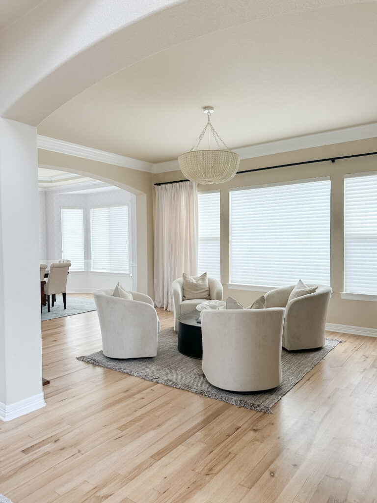 Cozy seating area with swivel chairs and a beaded chandelier