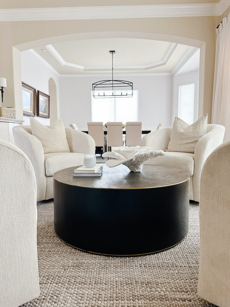 Cozy seating area with swivel chairs and a beaded chandelier