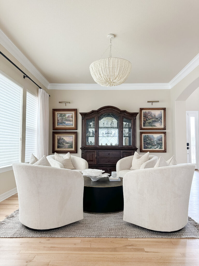 Cozy seating area with swivel chairs and a beaded chandelier